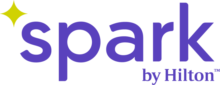 Logo of Spark by Hilton with purple text and a yellow star on a white background