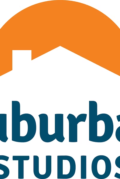 A logo-style graphic with an orange semicircle above a white house silhouette and the words "Suburbans STUDIOS" in dark blue on a white background.