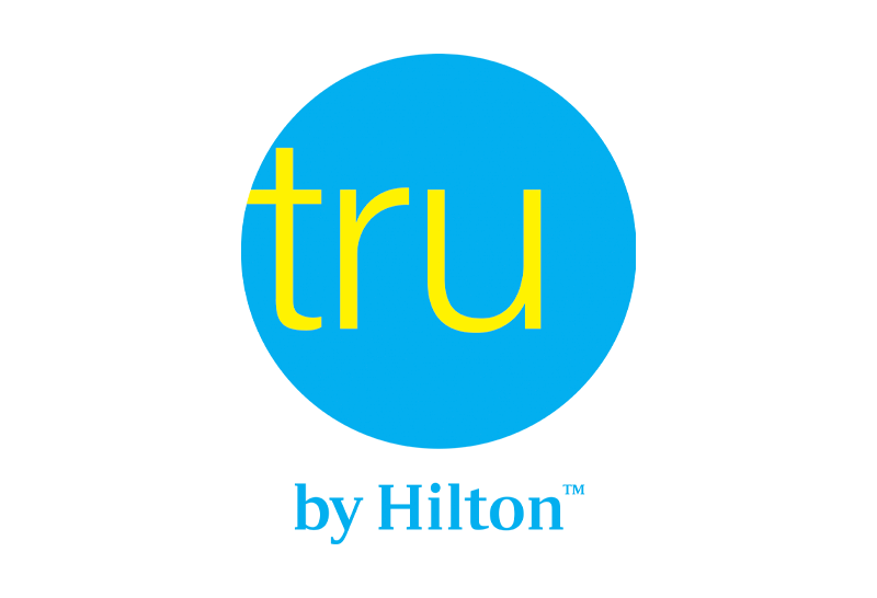 Logo of tru by Hilton with blue circle and yellow text on a white background